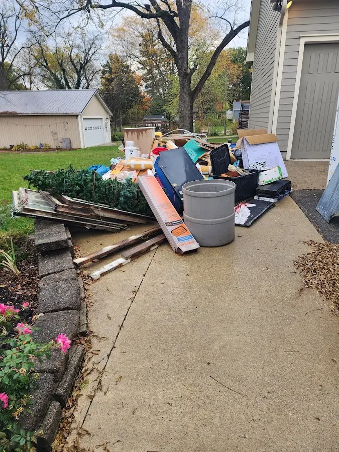 Dumpster being loaded with debris for Demolition Dumpster Rental in Speedway